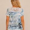 A329F9D8-7873-4FB0-98AB-B70915764511 Kalisson blue floral lace top with abstract botanical print, short sleeves and lightweight cotton blend fabric.
