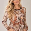 01: womens-abstract-face-print-top.webp Women's abstract face print long-sleeve top in beige, rust, brown and black tones