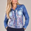 01womens-blue-printed-denim-shirt.webp Kalisson Women's blue printed denim-effect shirt with floral front panel and chest pockets