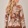 02: womens-abstract-face-print-top.webp Women's abstract face print long-sleeve top in beige, rust, brown and black tones