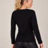 02womens-multicolour-printed-knit-top.webp Kalisson Women's multicolour printed knit top with black sleeves and decorative gold-tone buttons