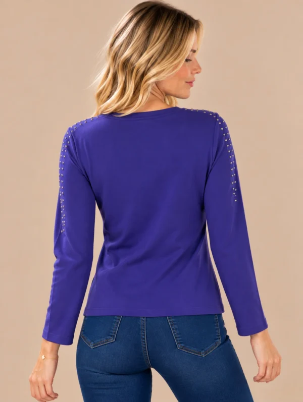 02purple-stud-detail-long-sleeve-top.webp Purple long sleeve top with metallic stud detailing around the neckline and shoulders