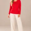 02red-studded-long-sleeve-top.webp Kalisson Women's red cotton long sleeve top with decorative dark stud detailing