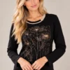 03black-floral-print-cotton-top.webp Women's black cotton long-sleeve top with gold-tone floral print and contrasting round neckline