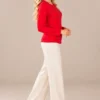 03red-studded-long-sleeve-top.webp Kalisson Women's red cotton long sleeve top with decorative dark stud detailing